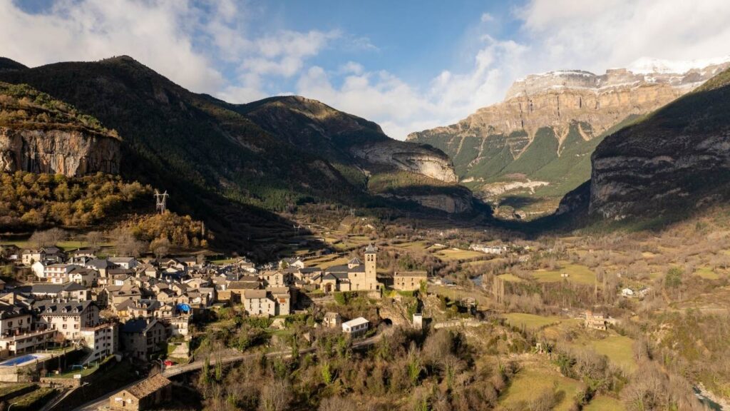 Pueblo de Torla y Valle de Ordesa con montañas nevadas en el Pirineo Aragonés. Destinos de nieve en España en invierno.