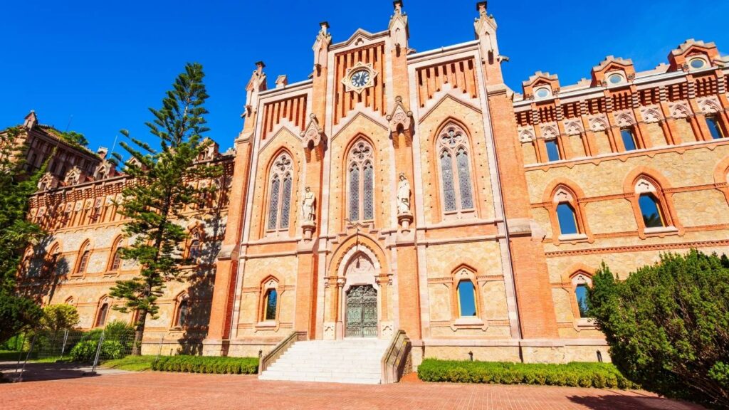 Primer plano de la fachada principal de la Universidad Pontificia de Comillas con detalles arquitectónicos.